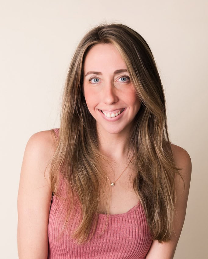 Bonnie Sorsby smiling in a soft pink top against a neutral beige background — creative director brand energetics expert and strategist business astrologer artist designer photographer