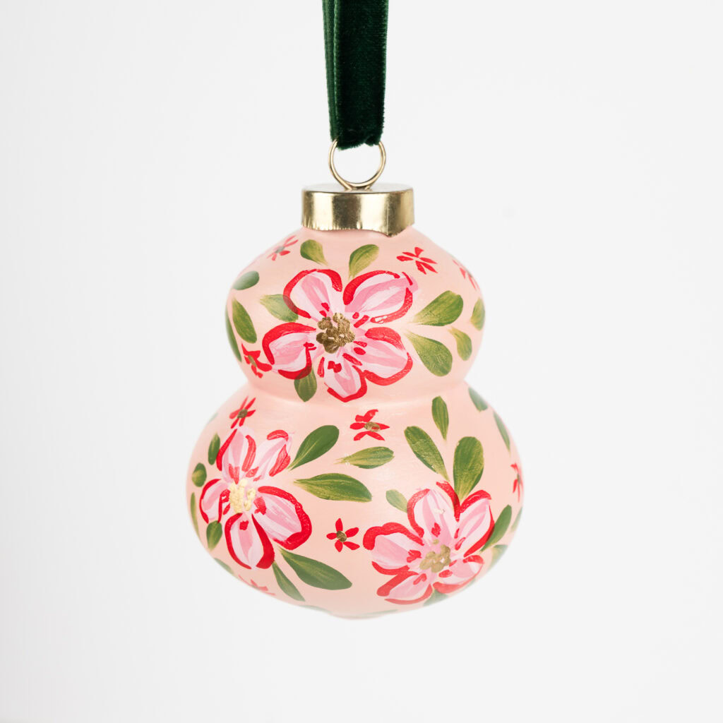 Vibrant red floral ornament with gold details; artist-painted in Florida, ideal for colorful living and bold modern holiday decor.