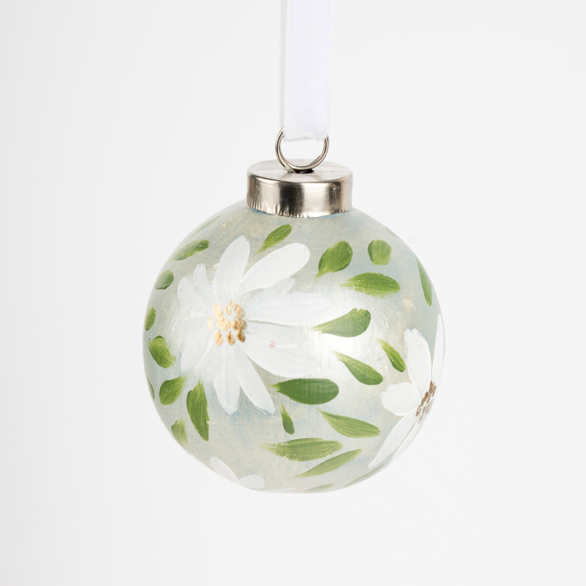 Hand-painted ceramic ornament in white and pale green with botanical florals by Florida artist; grandmillennial and modern cottage holiday style.