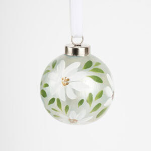 Hand-painted ceramic ornament in white and pale green with botanical florals by Florida artist; grandmillennial and modern cottage holiday style.