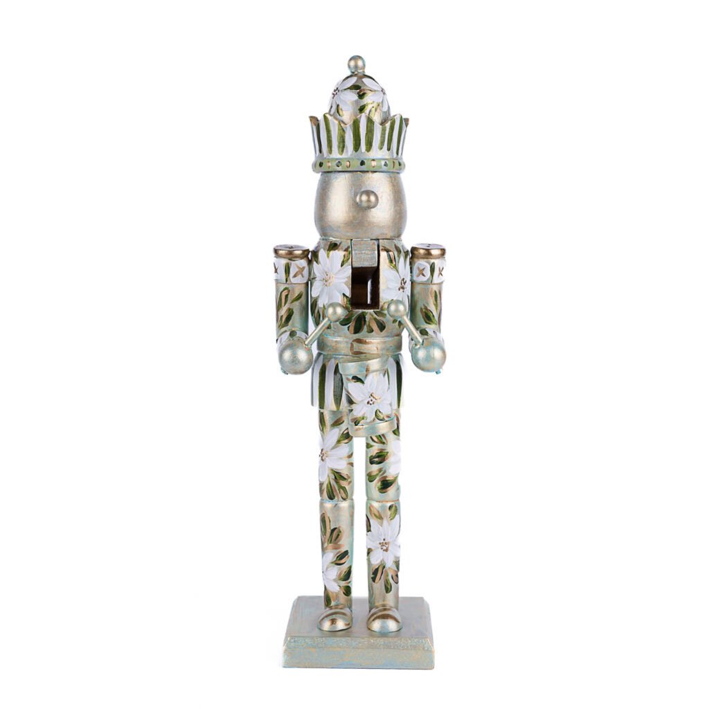 White floral nutcracker with gold and green hand-painted details; elegant neutral holiday decor by Florida artist.