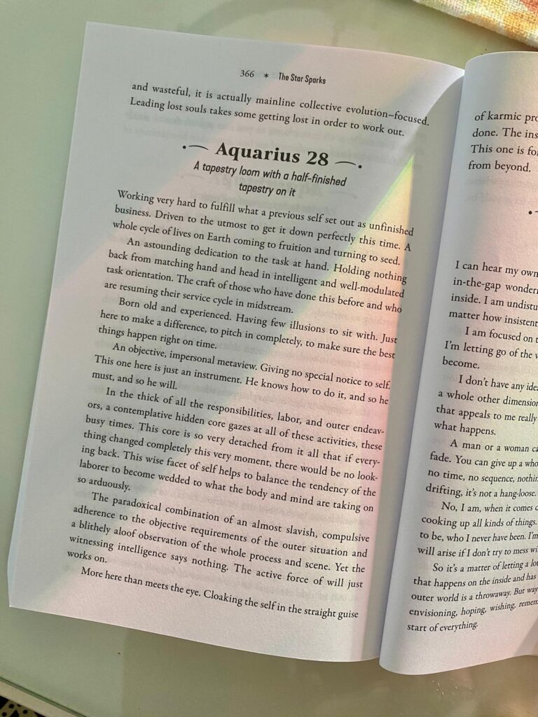 Open astrology book showing the Aquarius 30 degree passage titled “A large pool filled with white water lilies in bloom.”
