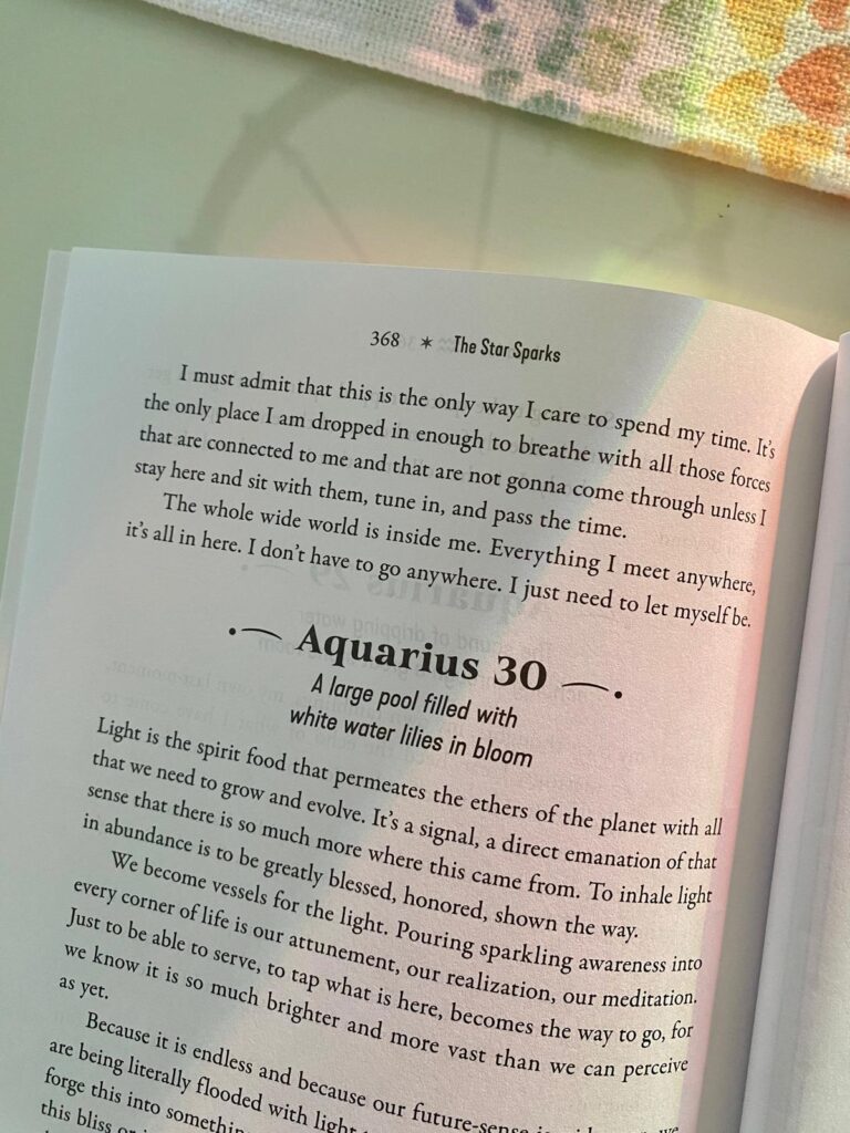 Astrology book page featuring Aquarius 28 degrees, titled “A tapestry loom with a half-finished tapestry on it.”