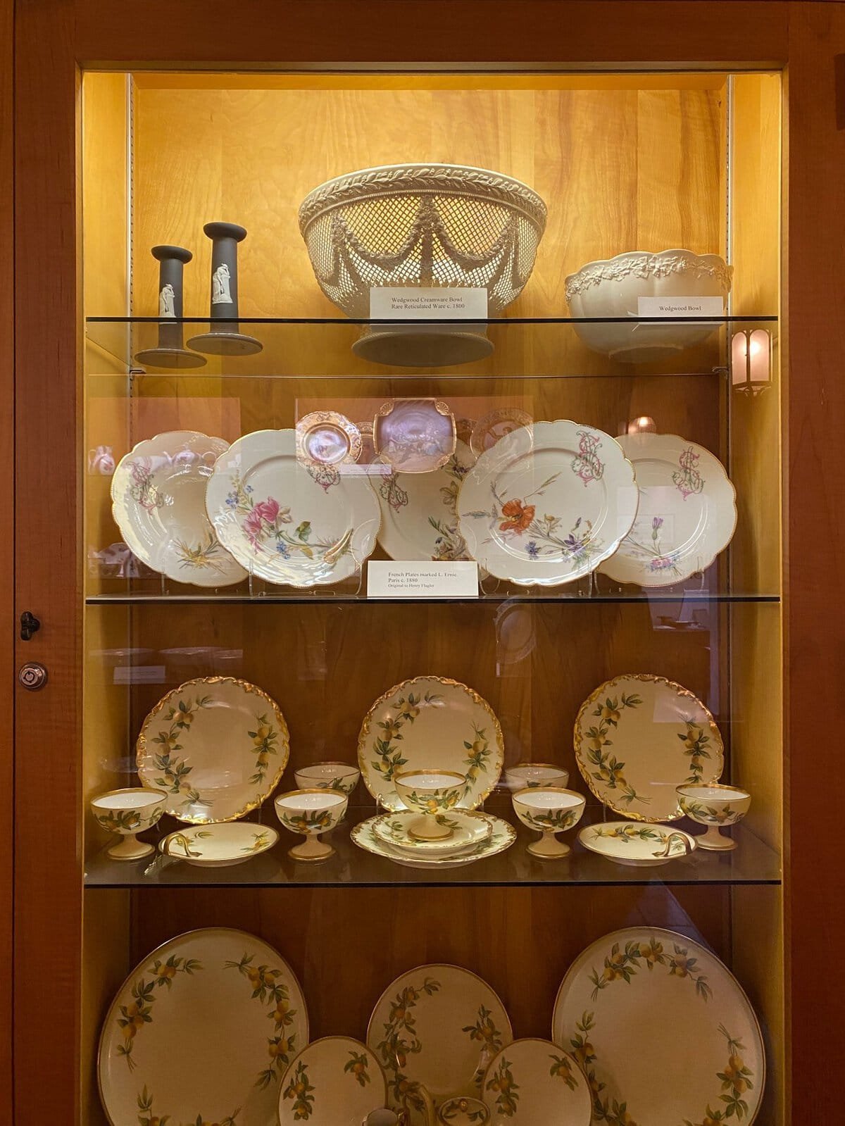 antique hand-painted china in a display cabinet at the Flagler Museum