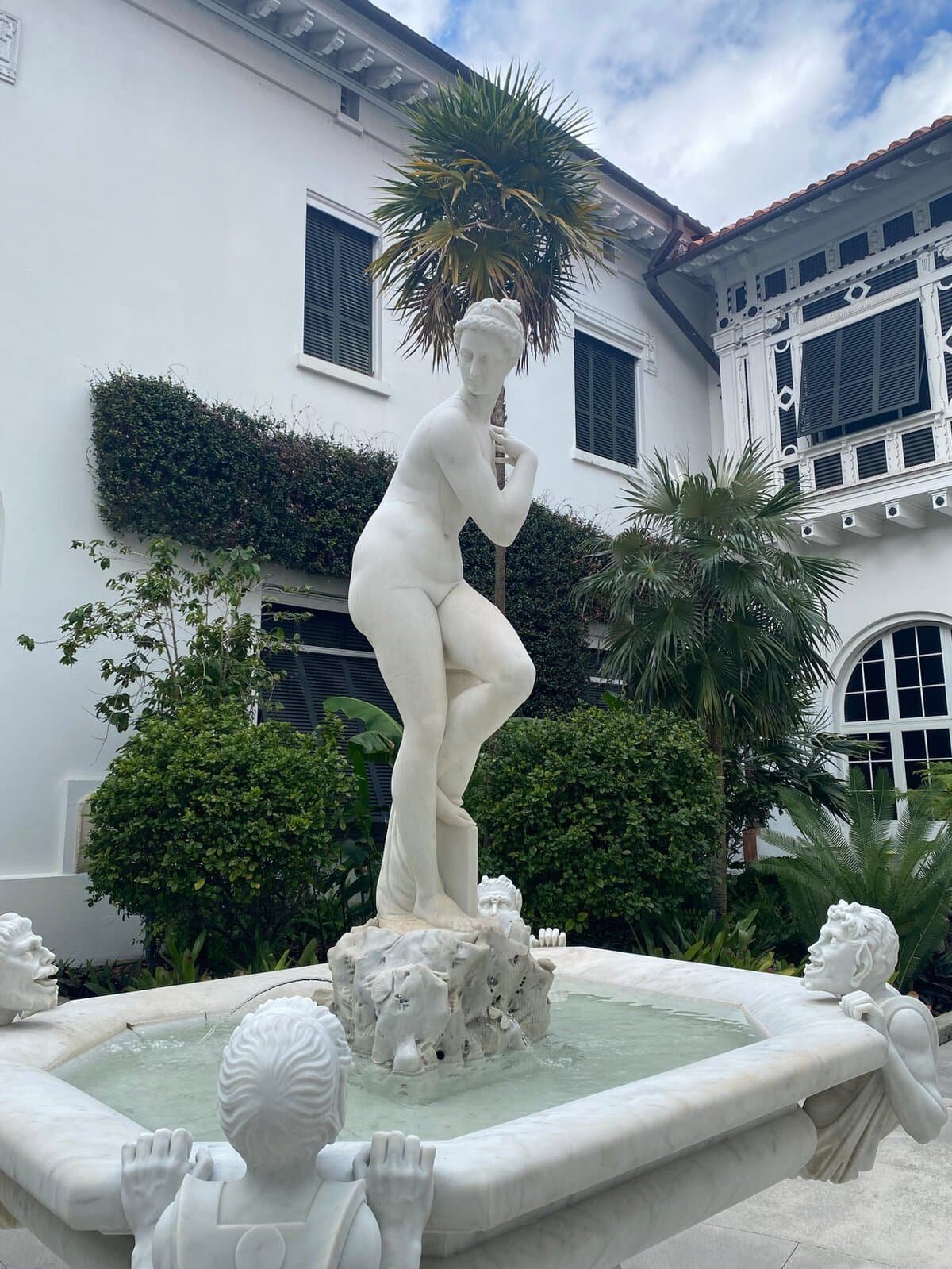 marble statue fountain in a courtyard garden in Palm Beach